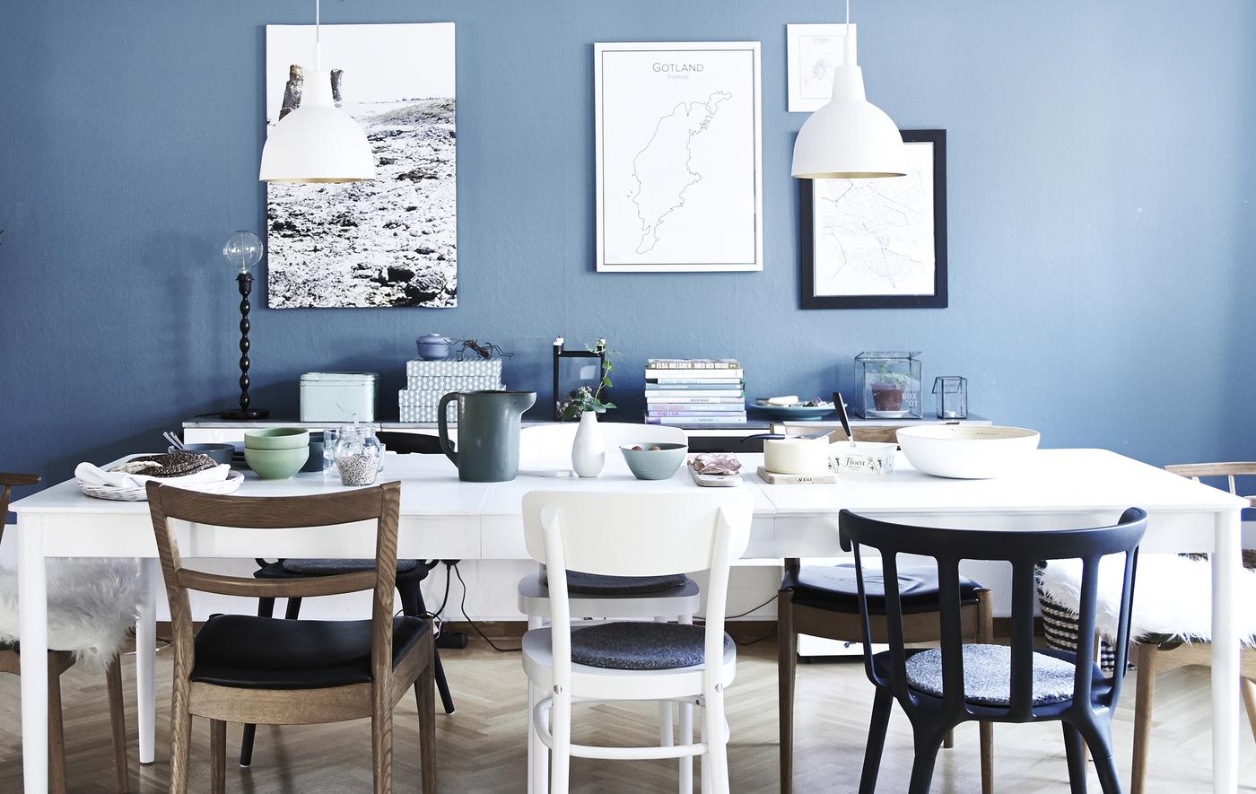 A white dining area against a blue wall.