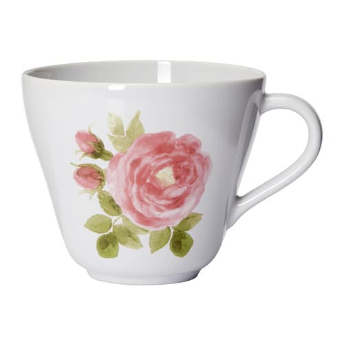 A white jumbo mug with a pink rose and green petals painted on it against a white background.