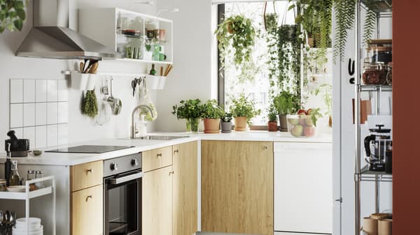 A white kitchen with oak colored cabinet doors.