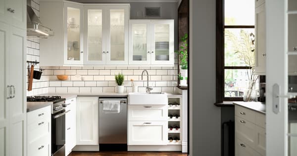 A white kitchen with stainless steel appliances.