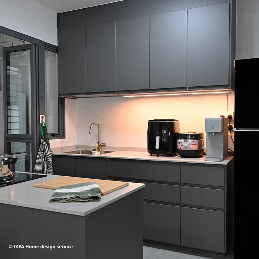 A wide shot of a contemporary style kitchen from a 4-room BTO flat in Woodlands, Singapore, designed by IKEA Home design service.  