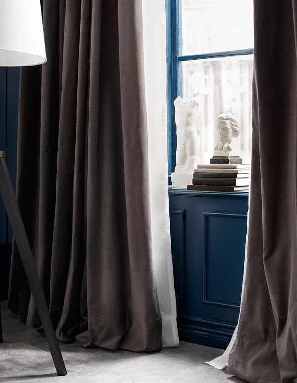 A window with two layers of curtains.