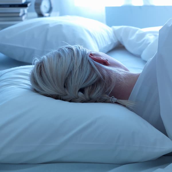 A woman asleep on her side.