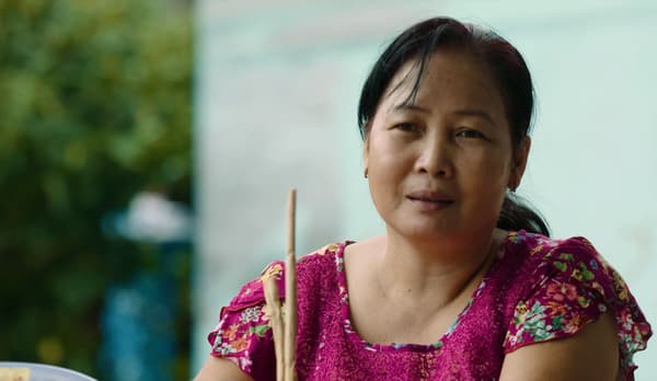 A woman from Vietnam in a pink blouse. 