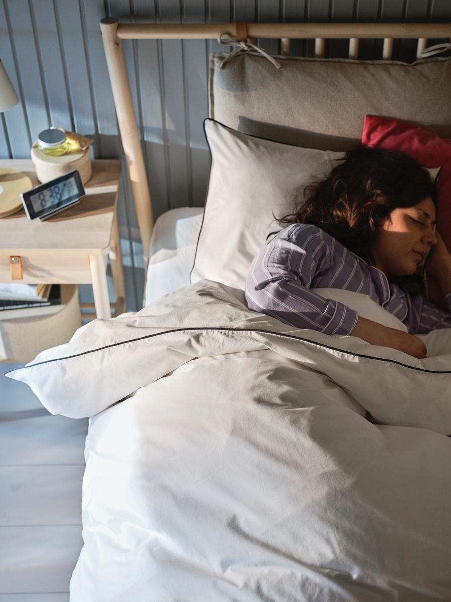 A woman sleeping facing the opposite side of the window