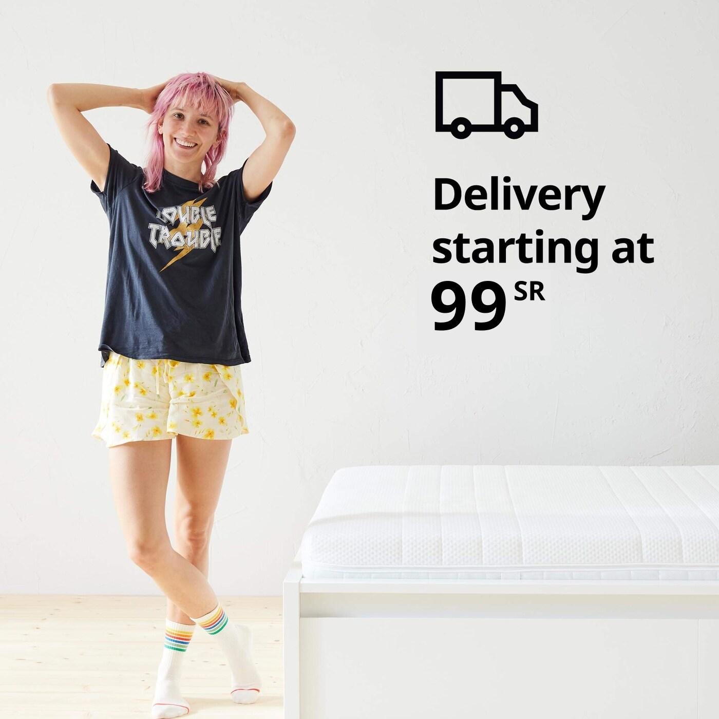 A woman standing in her pajamas next to a bed and a delivery truck symbol and the text 'Delivery starting at $19' on the image.