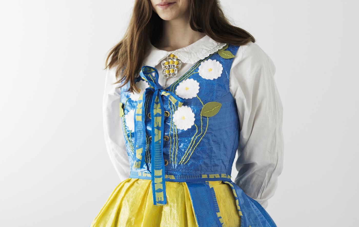 A woman wearing a dress made from IKEA FRAKTA bags.