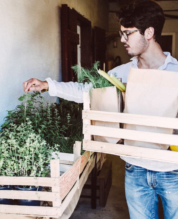 A young man selecting ingredients from a farmers market.