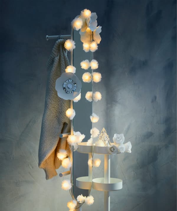 Add more holiday magic by framing a mirror with IKEA LIVSÅR LED lighting chain.