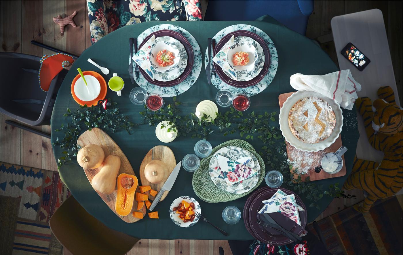 Aerial image of an IKEA INGATORP dining table covered in plates, cutlery and food.