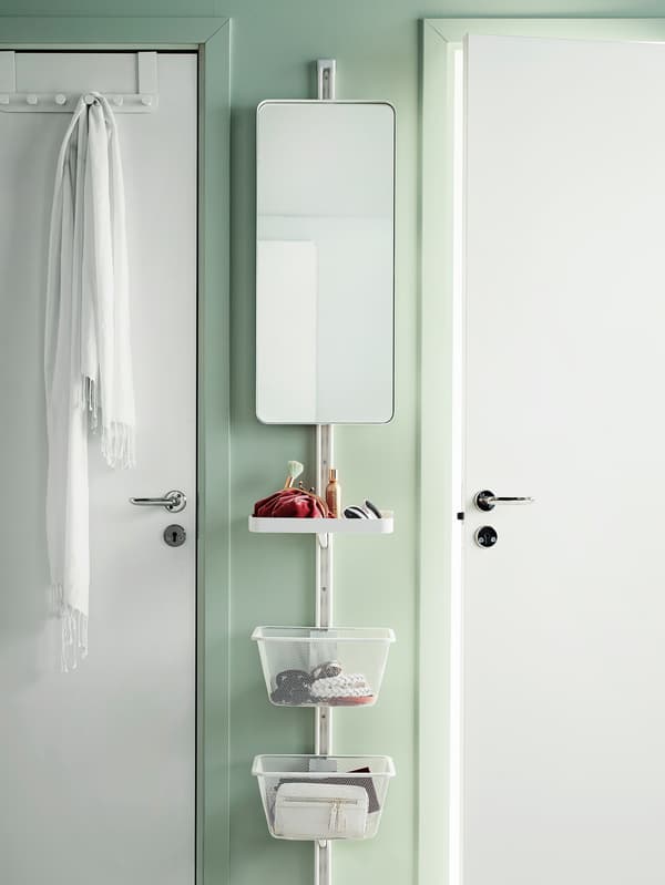 ALGOT storage mounted vertically on a narrow piece of wall between two doors. Includes a mirror, shelf and baskets.