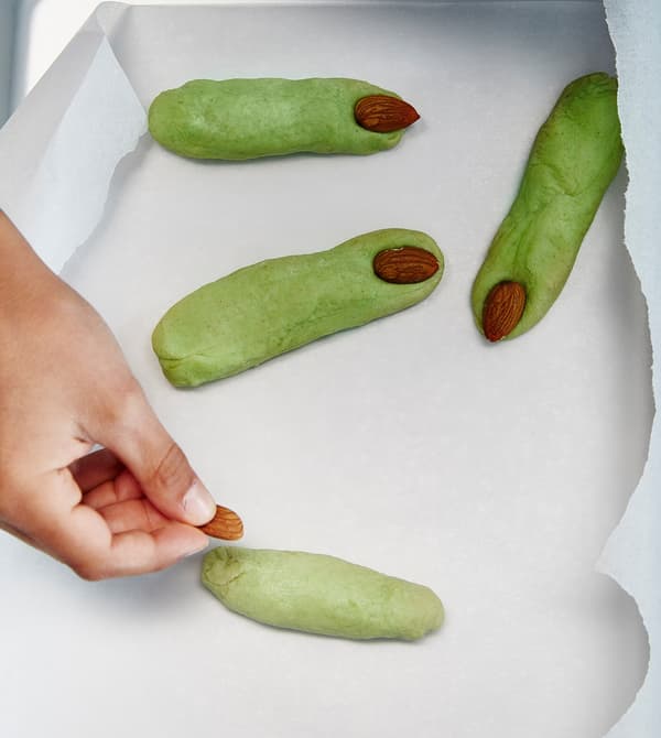 Almonds are placed onto shortbreads that look like witches’ fingers.
