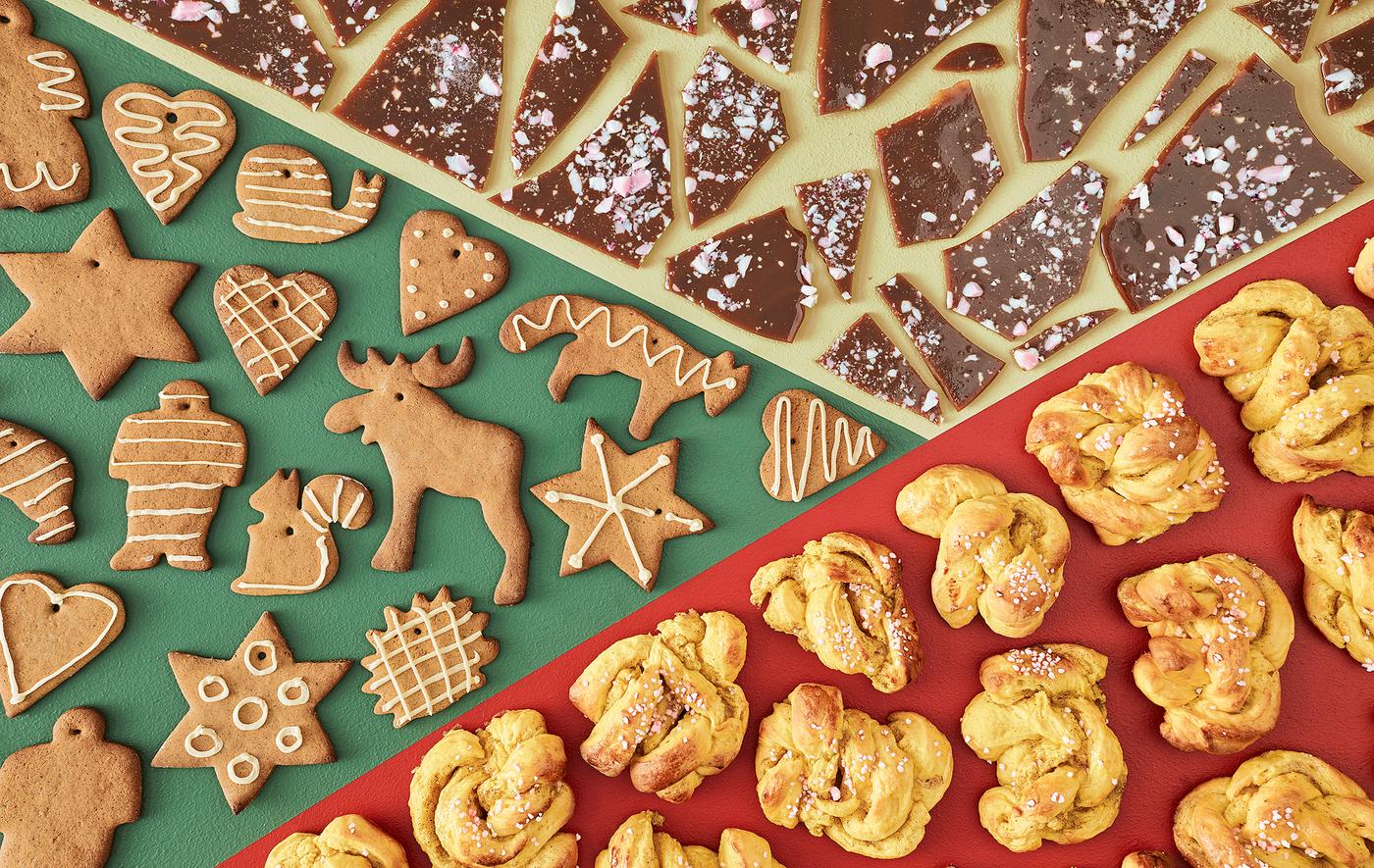 An aerial view of toffee pieces, gingerbread cookies and saffron buns