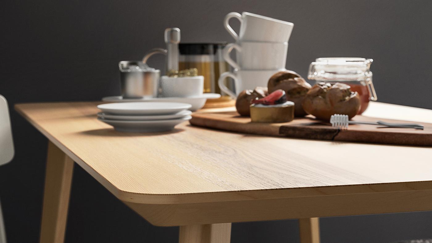 An ash veneer LISABO table top holding coffee cups and a cutting board with a jar of honey and some buns.
