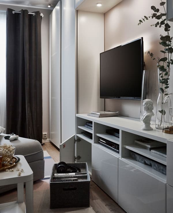 An entertainment centre is set up with open and closed storage, interior organisers and a larger tv.