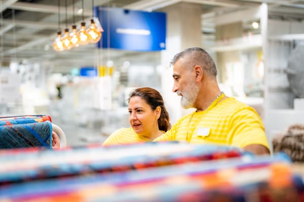 An IKEA co-worker helping a customer design their kitchen in the Kitchen planner tool.