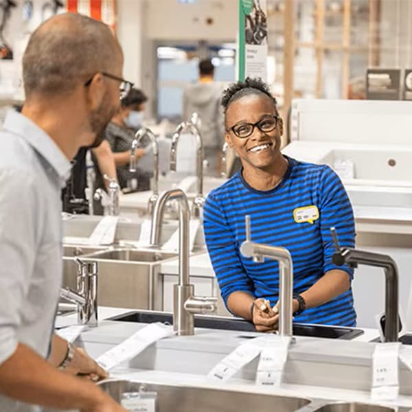 An IKEA co-worker helping customers plan their kitchen in-store