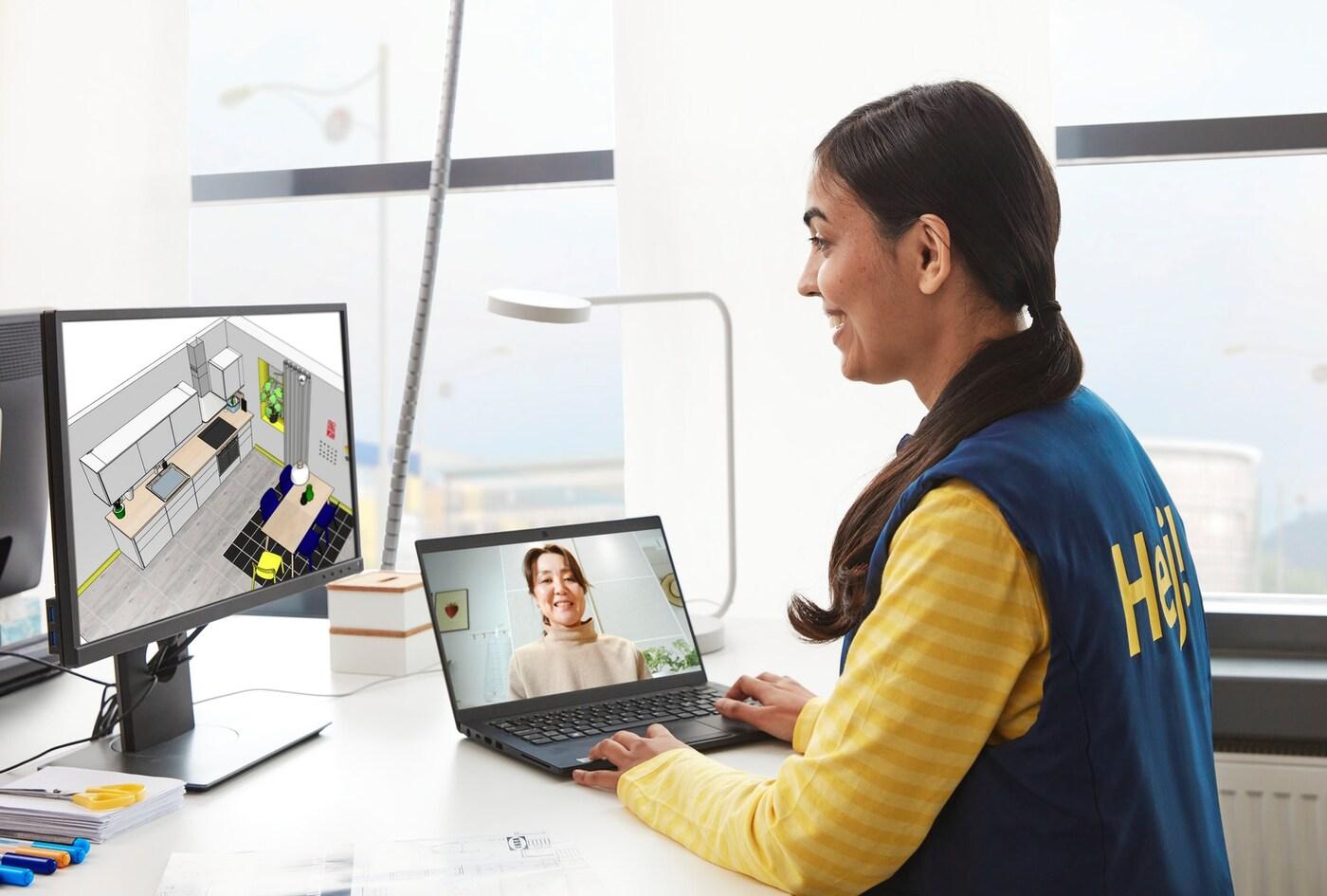 An IKEA coworker on laptop doing a video online kitchen planning session with a customer