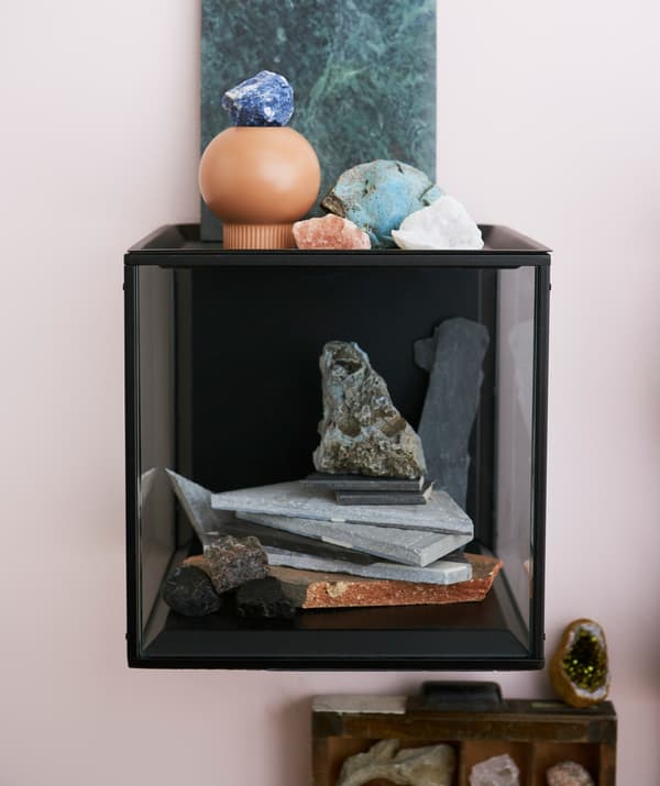An IKEA SAMMANHANG display box filled with stones and crystals.