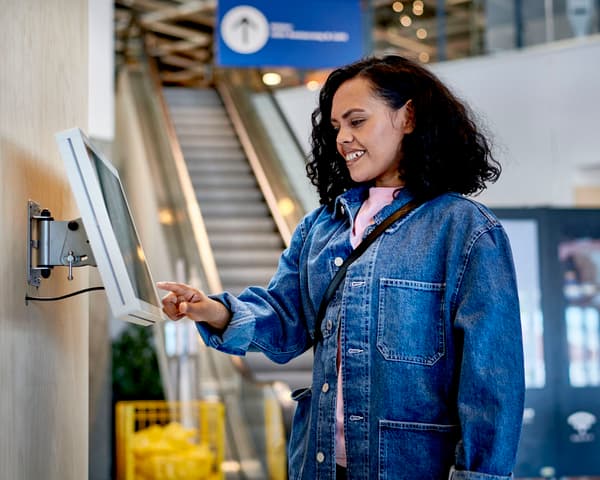 An ikea shopper using an in store kiosk