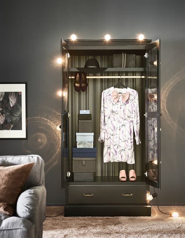 An IKEA UNDREDAL wardrobe opened to show clothes hanging.