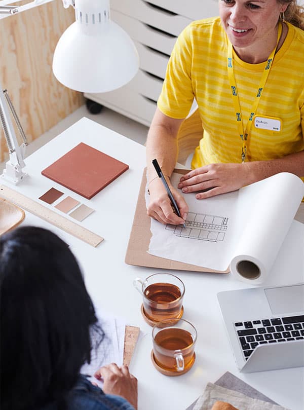 an interior designer planning a room with a client
