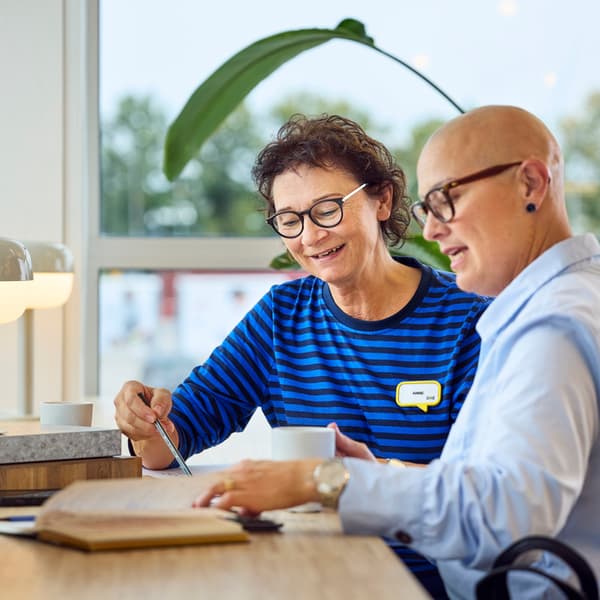 An interior designer talking to a customer about plans.