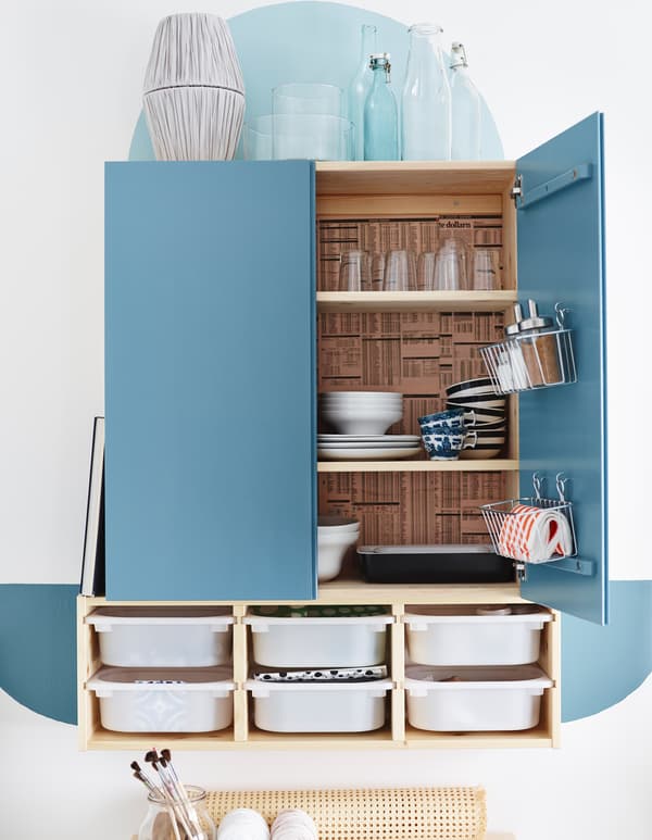 An IVAR cabinet painted and turned into a dining cabinet with baskets attached to the doors and wall storage drawers underneath