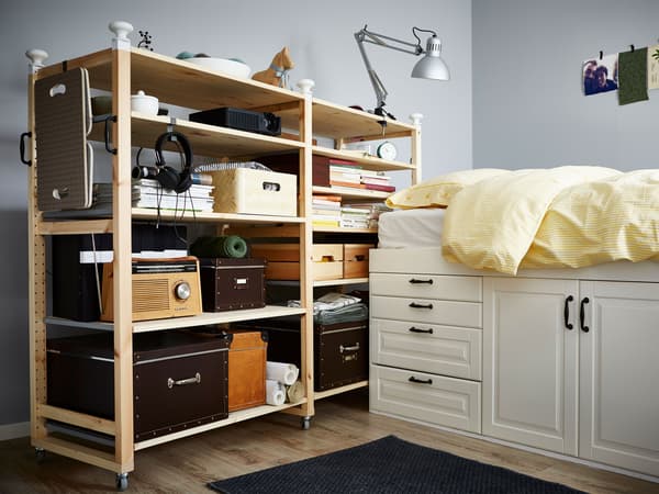 An IVAR shelf on wheels with storage boxes