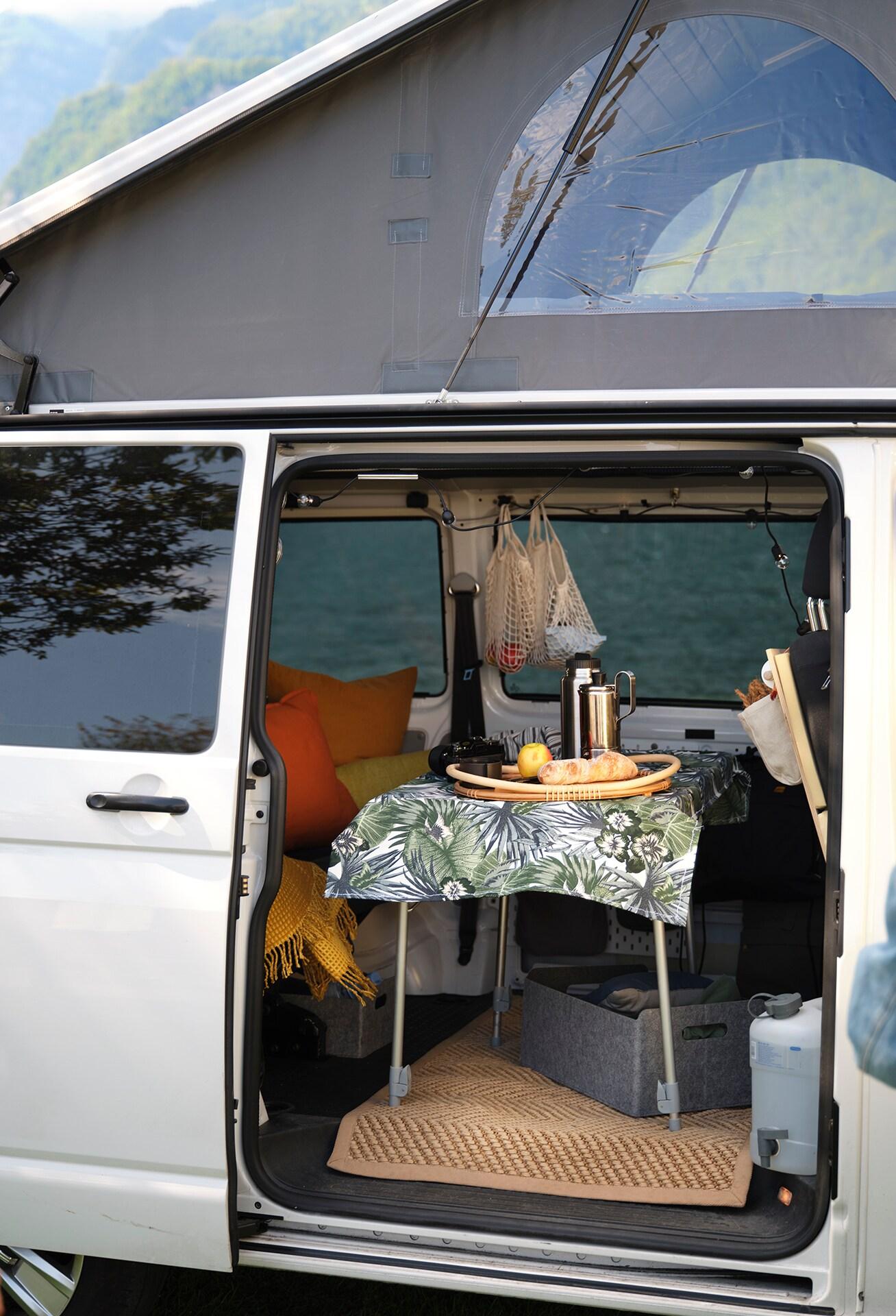 An open door van with a picnic table inside