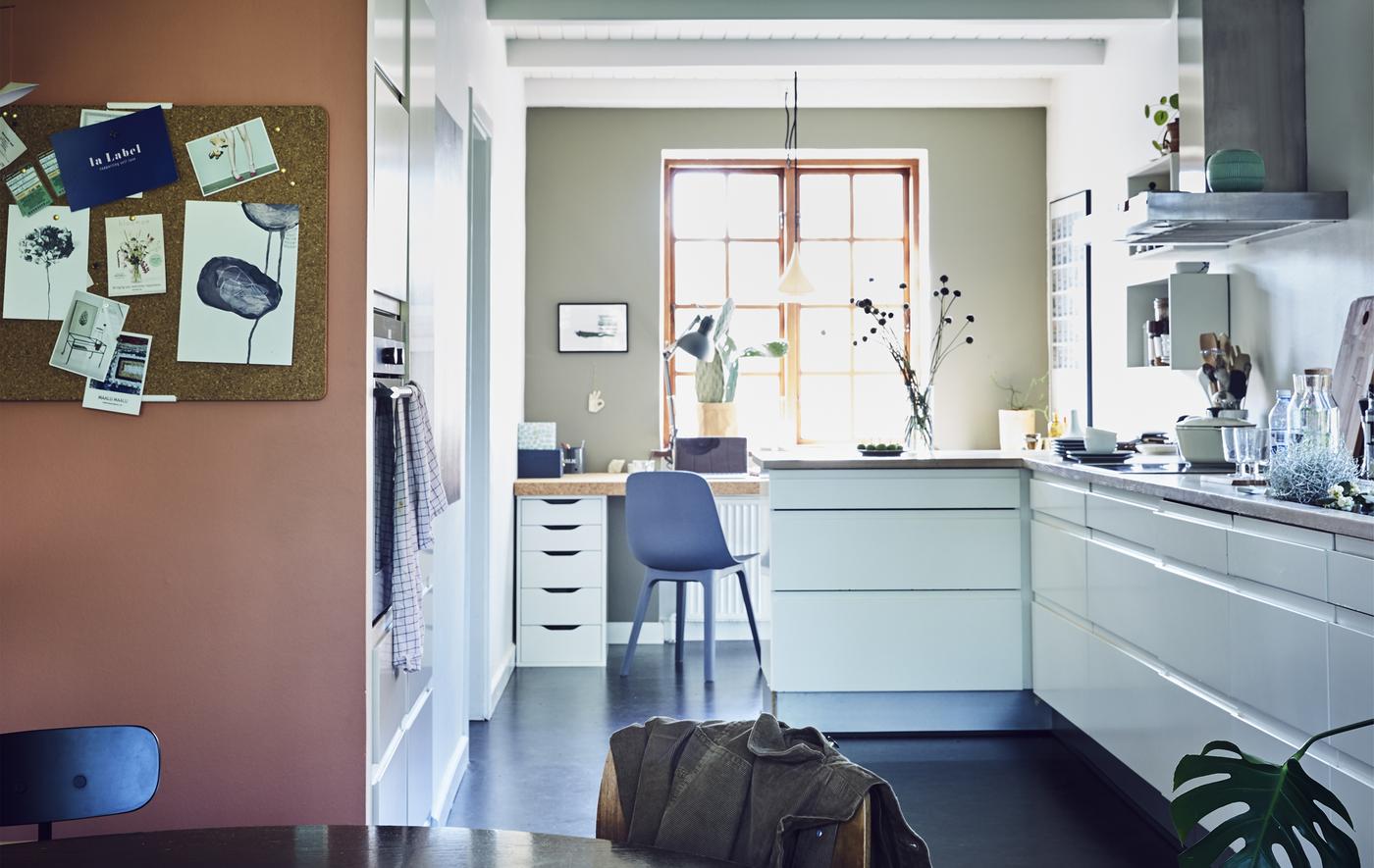 An open-plan white kitchen and dining area.