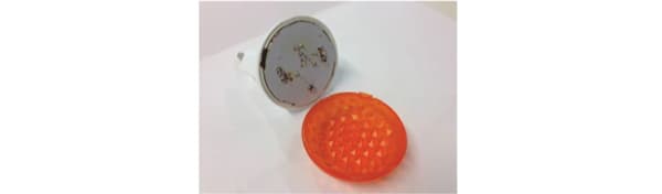 An orange nightlight split open to reveal the inside mechanism.