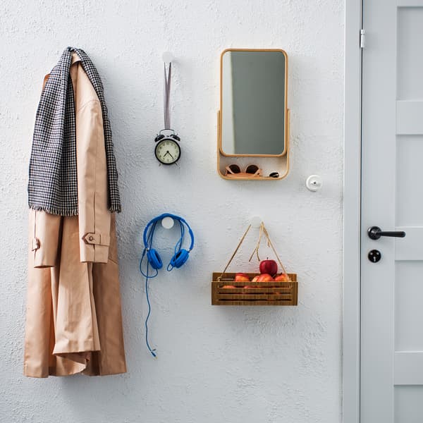 An organised wall with knobs by the door.