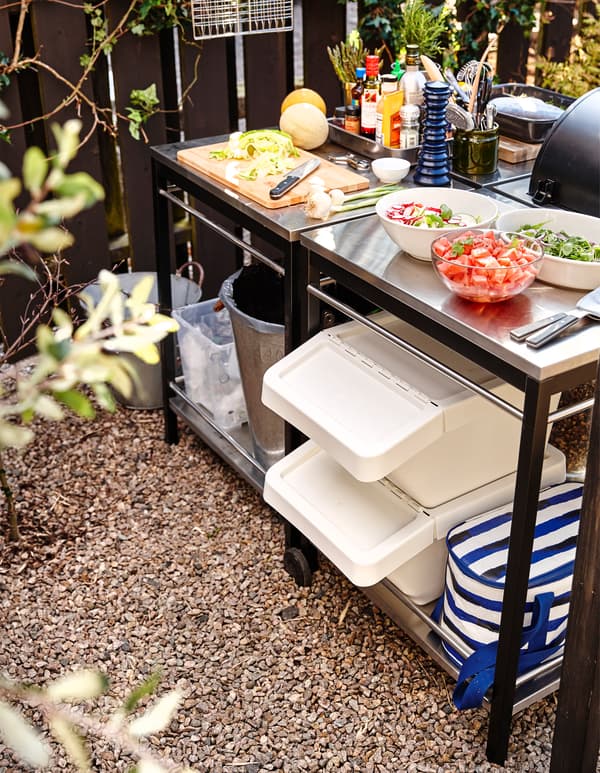 An outdoor kitchen prepping area with workspace for making salads and side dishes.