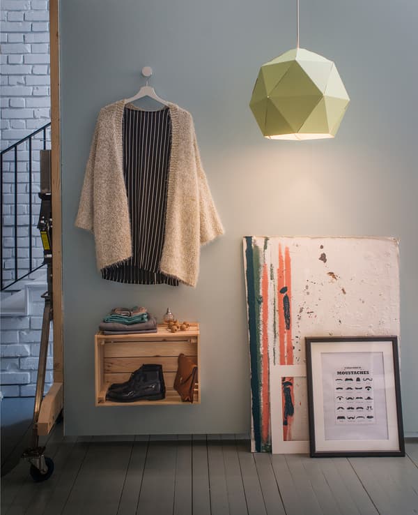 An outfit and shoes on a wall.