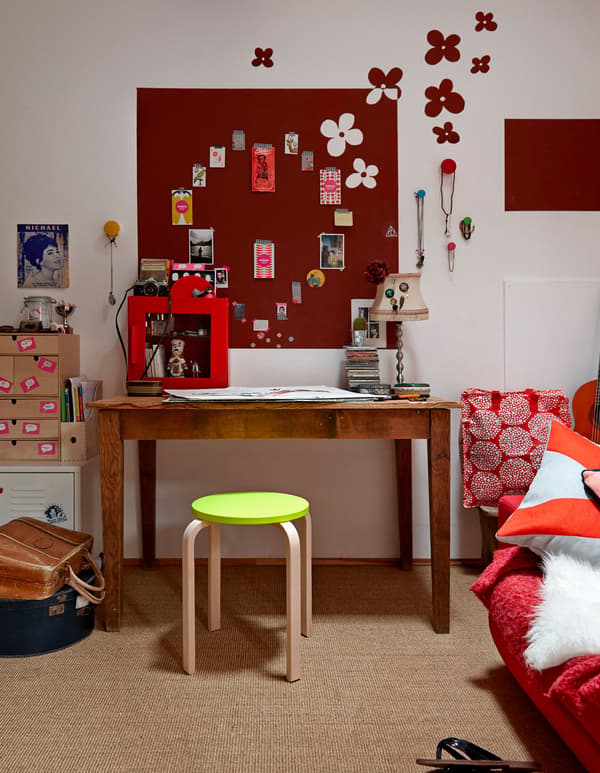 An overview of Lison's desk and workspace, including a red board with paper clippings arranged into a heart shape.