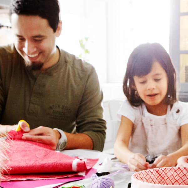 An parent and his child are doing crafts together, one of the themes of the IKEA Let’s Play campaign.