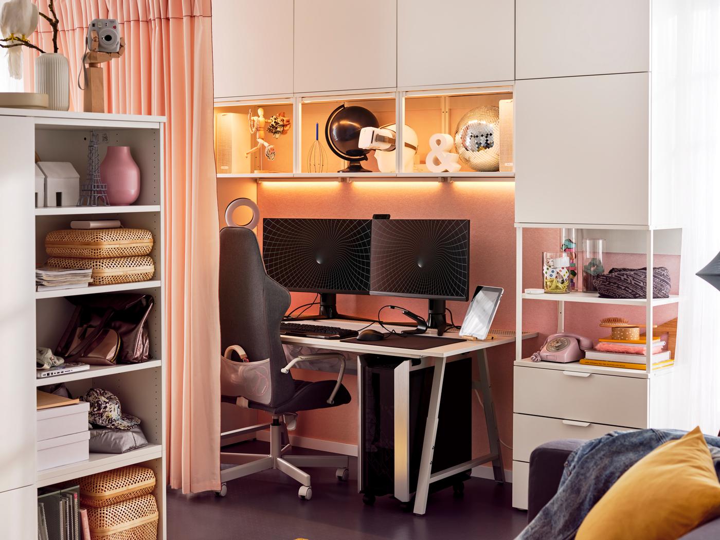 An UTESPELARE gaming chair and desk surrounded by a white PLATSA storage combination holding gaming and other accessories.