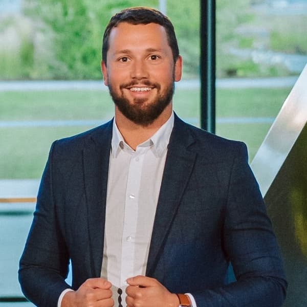 Anrijs Tukulis, energy efficiency expert is smiling dressed in suit.