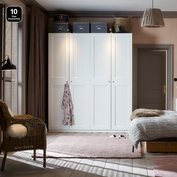 Bedroom showcasing a White PAX wardrobe with white Grimo doors
