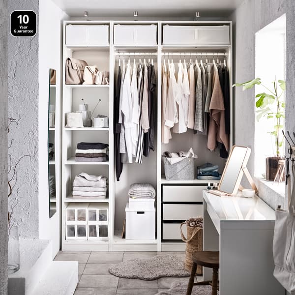 Bedroom showcasing a white wardrobe without doors