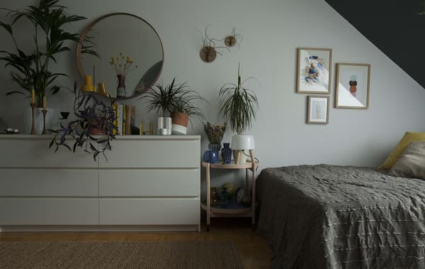 Bedroom with a bed and plants.