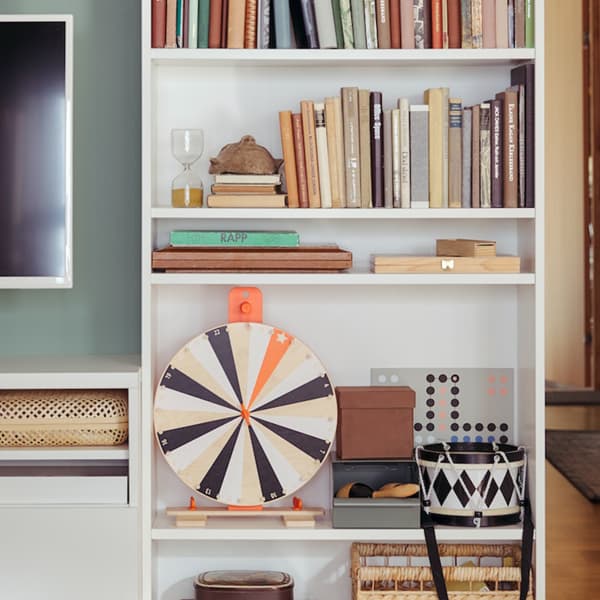BILLY bookcase in living room next to television, with books, games and more displayed