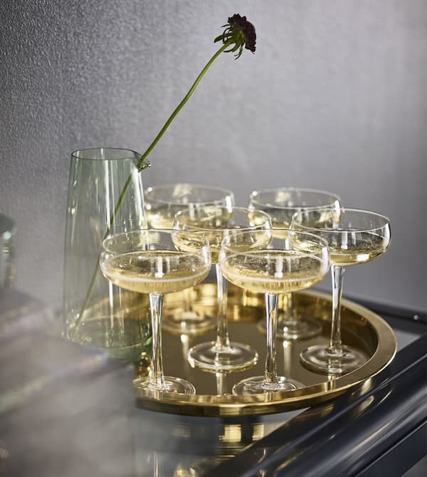 Brass furniture can help a darker room feel light. IKEA has a variety like round GLATTIS tray in brass-coloured, metallised steel.