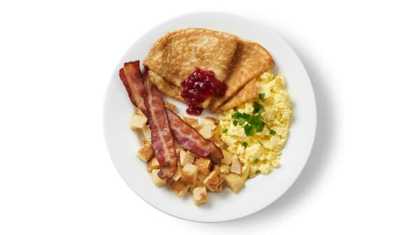 Breakfast Plate with Pancakes. Served with Eggs, Potatoes and Bacon with Swedish Pancakes and Lingonberry Jam