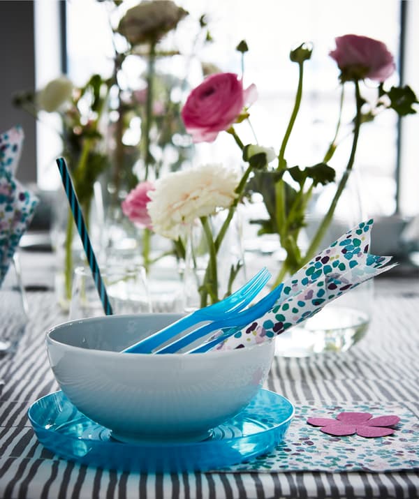 Celebrate with a modern table setting in muted hues and shots of playful colors.