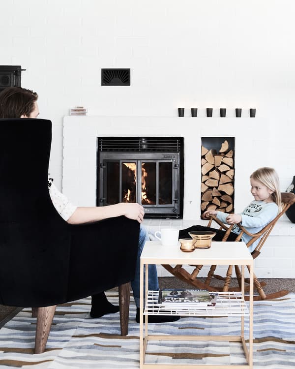 Chairs create a sociable space by the fire.