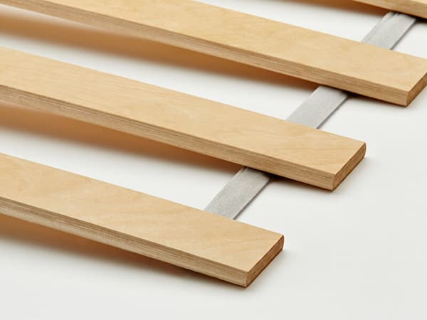 Close-up of a wooden slatted bed base.