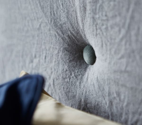 Close-up of buttons on a sofa made from mattresses