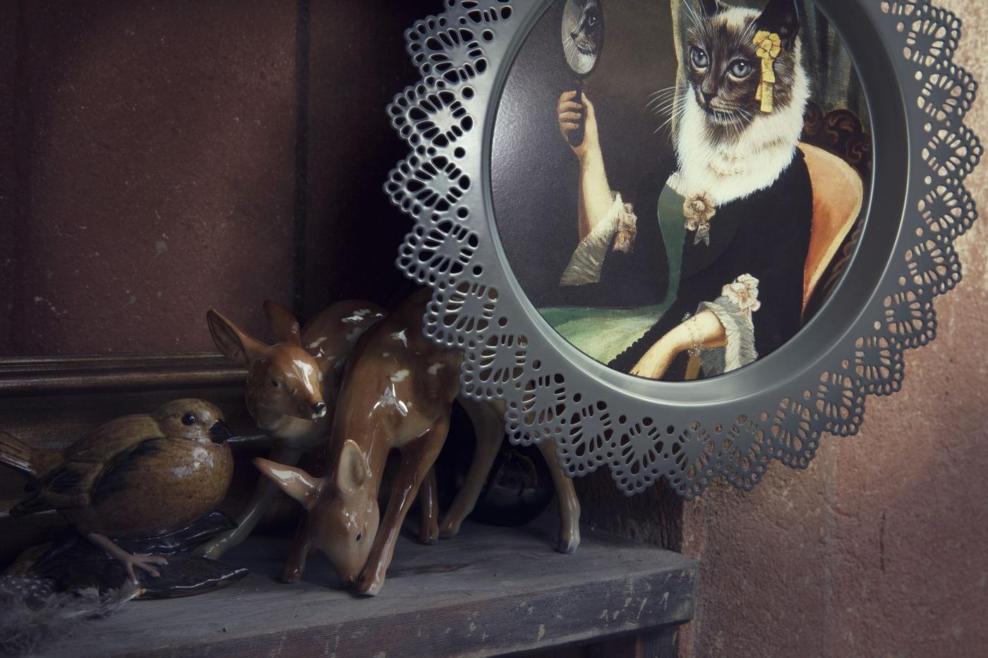 Close up of IKEA SKURAR wall decoration with cat and animal ornaments